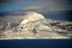 06 Sun Shines On A Glacier Clad Mountain On Anvers Island Near Cuverville Island From Quark Expeditions Antarctica Cruise Ship.jpg